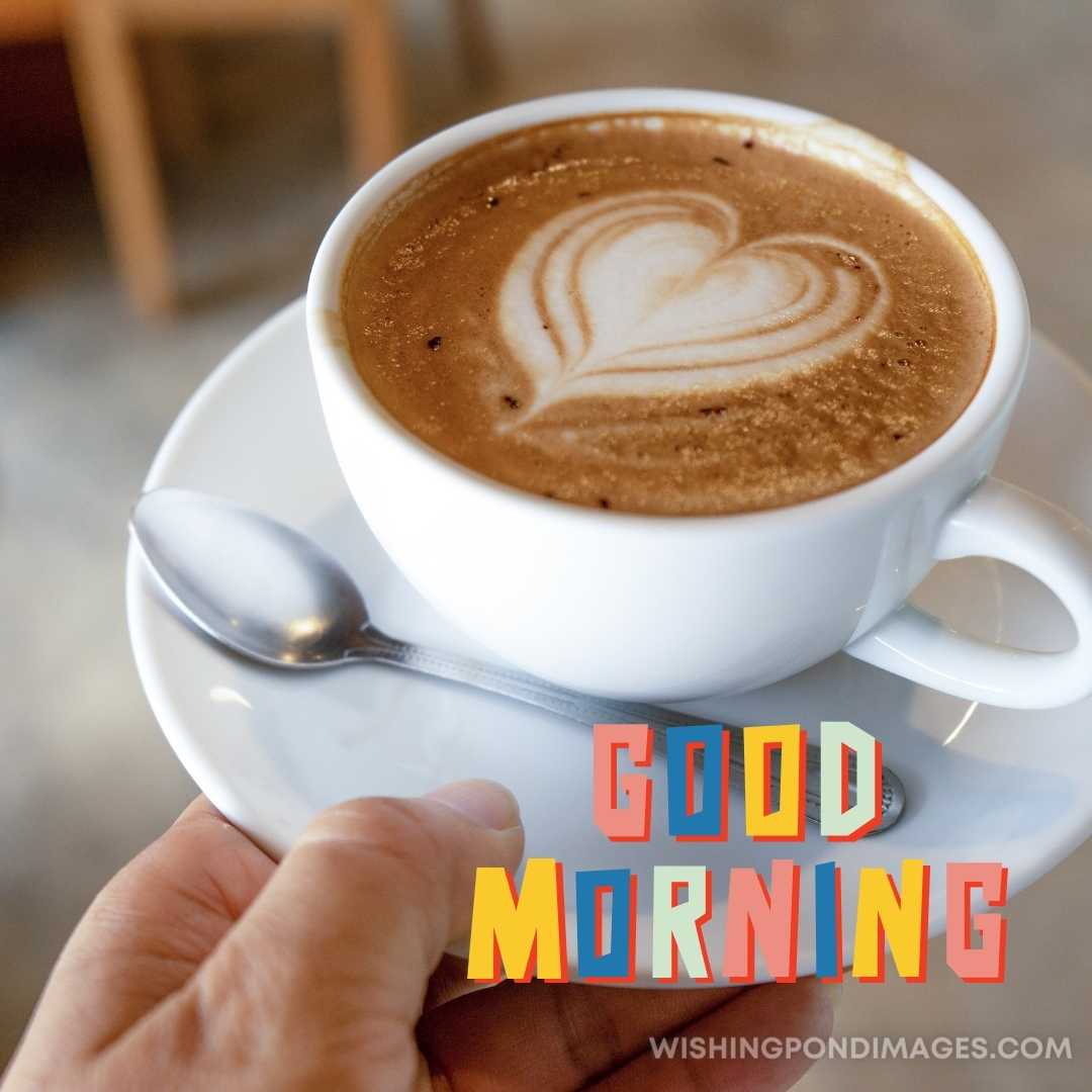 A man hands holding coffee cup in a plate with spoon. Good Morning Coffee Images